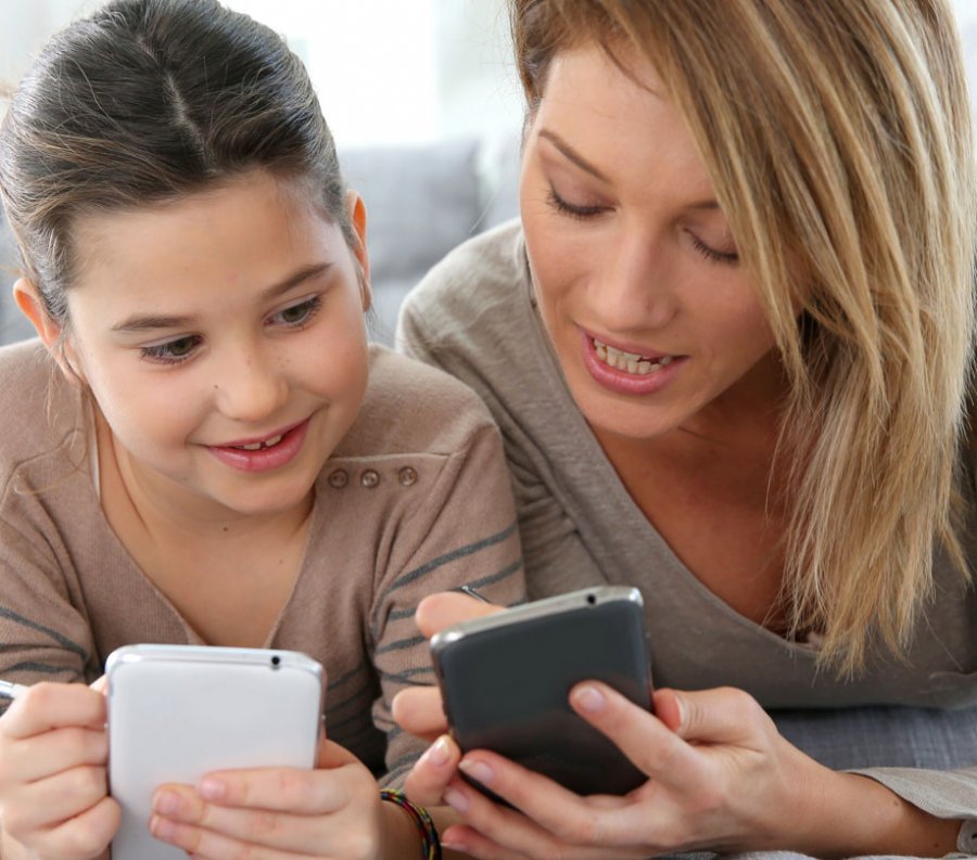 Mother and Daughter Playing Mobile Games on SmartPhone App Developer Magazine